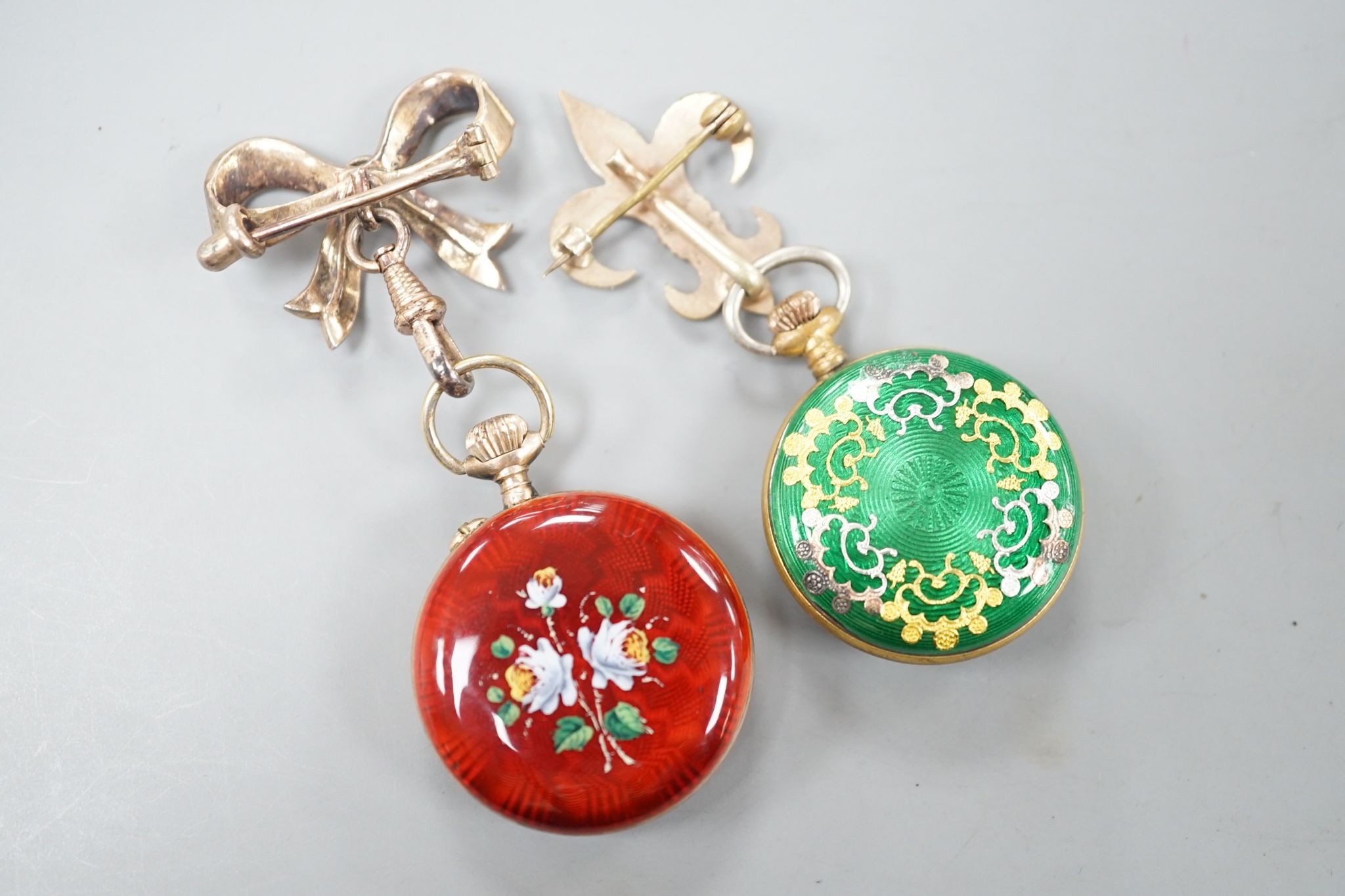 Two lady's early 20th century gilt metal and enamelled fob watches, on enamelled suspension brooches.